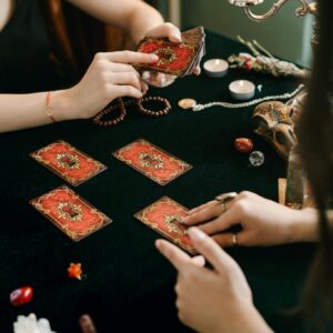 A tarot card reading session with crystals and candles, creating a mystical atmosphere.